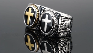 Detail of vintage gothic cross rings with black enamel inlay and engraved band details