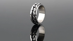 Detail of vintage rotating beer bottle opener ring with black cuban link chain design