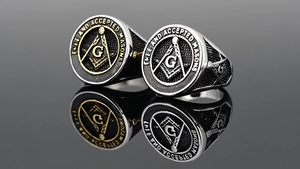 Detailed close-up of Freemason compass logo on a vintage stainless steel signet ring