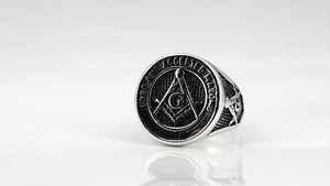 Macro detail of men's Masonic signet ring in vintage steel with Freemason engraving