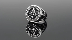 Macro shot of retro Masonic signet ring in polished titanium steel with black details