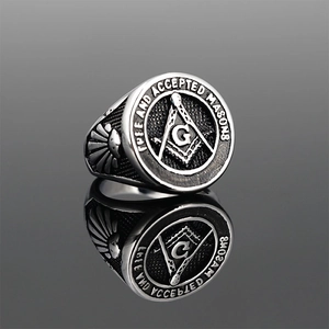 Vintage stainless steel Masonic G ring with round compass crest on mirrored background