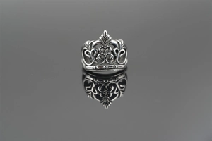 Macro shot of vintage crown ring with gothic hollow carvings and retro oxidized finish