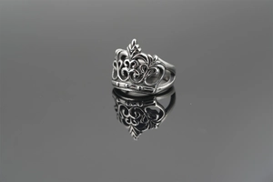Detailed close-up of retro titanium steel crown ring with intricate vintage engraving