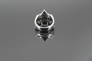 Macro shot of silver vintage crown ring showing intricate hollow patterns and texture