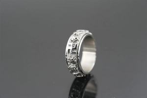 Detail view of rotating spinner ring with vintage pattern and relief engraving