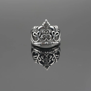 Retro crown ring in vintage titanium steel featuring intricate hollow vine patterns