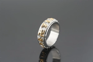 Detailed close-up of rotating stainless steel ring with embossed golden mantras