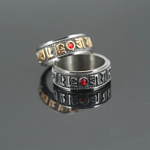 Rotating stainless steel mantra ring with red zircon inlay in vintage silver and gold finish
