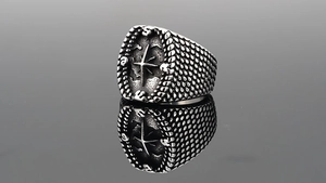 Macro shot of vintage compass ring with engraved starburst and textured metal band