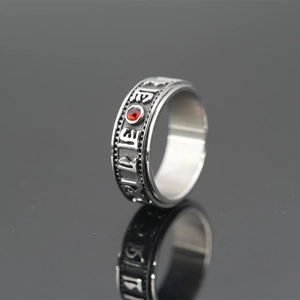 Rotating stainless steel Buddhist mantra ring with red gemstone and vintage finish