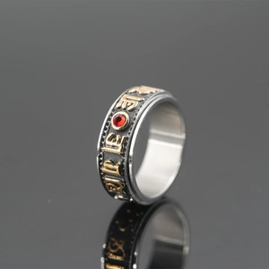 Rotating stainless steel Buddhist mantra ring with red gemstone and vintage gold finish