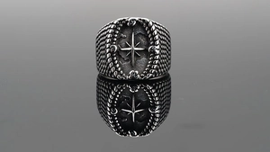 Close-up of vintage compass star ring with engraved N S E W letters and nautical details