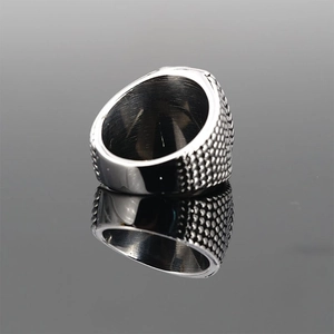 Polished silver stainless steel ring with intricate honeycomb pattern on black background