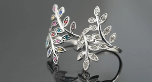 Macro shot of leaf branch ring featuring multicolor zircon stones on silver band
