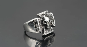 Close-up of vintage silver hiphop ring with cross and realistic skull design for men