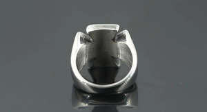 Detail of a brushed silver iron cross ring with polished edges for men's hip hop style