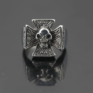 Gothic punk 3D skull and iron cross ring in vintage silver finish on mirror background