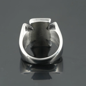Gothic silver stainless steel ring with iron cross design on dark reflective surface