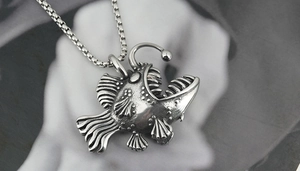 Detailed view of the antique silver anglerfish pendant with a classic box chain