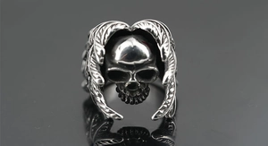 Detail shot of vintage skull ring featuring intricate wing engravings on silver steel
