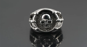 Macro detail of retro punk skull ring with glasses and eagle claws in vintage silver