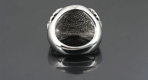 Detailed close-up showing the vintage textured inner surface of this silver punk skull ring