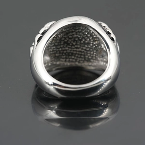 Vintage silver skull claw ring for men featuring textured punk style and brushed metal finish