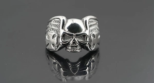 Macro view of vintage skull ring featuring side wing patterns and cross relief details