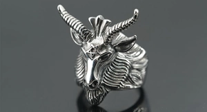 Macro shot of vintage silver steel ram head ring with pentagram and gothic textures