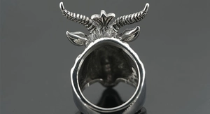 Macro detail of gothic goat head ring in vintage silver finish with spiral horn textures