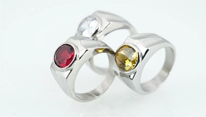Macro shot of titanium steel men's rings featuring red, white, and yellow cubic zirconia