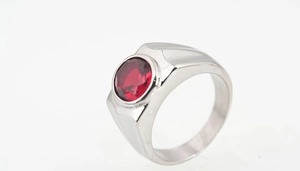 Macro shot of a men's titanium steel ring featuring a large round red zircon gemstone