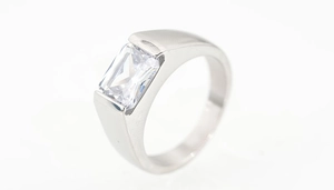 Detail view of emerald cut rectangular diamond set in a brushed titanium steel band