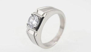 Macro side view of a titanium steel ring with brushed texture and clear round gemstone