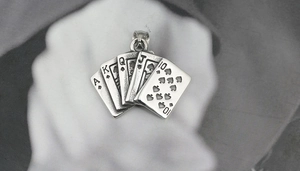 Detail view of vintage titanium steel poker card pendant featuring royal flush spades