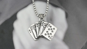 Close-up of vintage steel poker ace of spades royal flush pendant with box chain