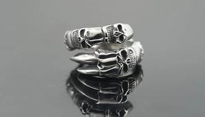 Detail of vintage silver dragon claw skull ring with gothic punk distressed finish