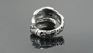 Close-up of gothic skull skeleton engraving on retro stainless steel dragon claw ring