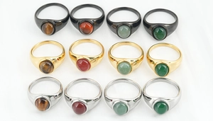 Macro shot of vintage signet rings in gold, silver and black with tiger eye stones