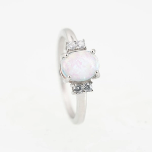 Anillo de plata pulida con piedra de opalo ovalada y piedras circulares de circonita clara