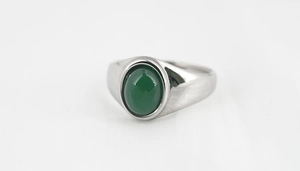 Macro shot of titanium steel signet ring featuring a polished oval green agate gemstone