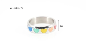 Close-up of 6mm wide titanium steel ring with colorful enamel hearts, weighing 4.7g