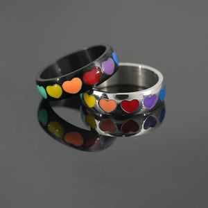 Rainbow enamel heart rings in black and silver stainless steel finish set on mirror base