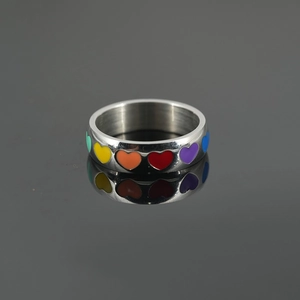 Polished stainless steel band ring with vibrant rainbow enamel hearts and mirror reflection