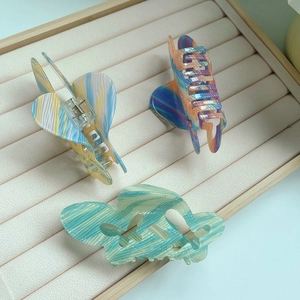 Three-piece set of marble pattern acrylic hair claws featuring elegant butterfly and geometric designs