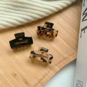 Three-piece set of acetate hair claws in black, tortoiseshell and marble patterns