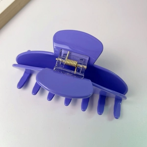 Macro view of large purple acetate hair claw clip showing internal springs and non-slip teeth