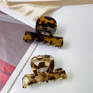 Elegant acetate geometric hair claw clips in marble and dark tortoiseshell patterns