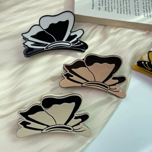 Set of three butterfly acetate hair claws in black, khaki, and beige silk textures